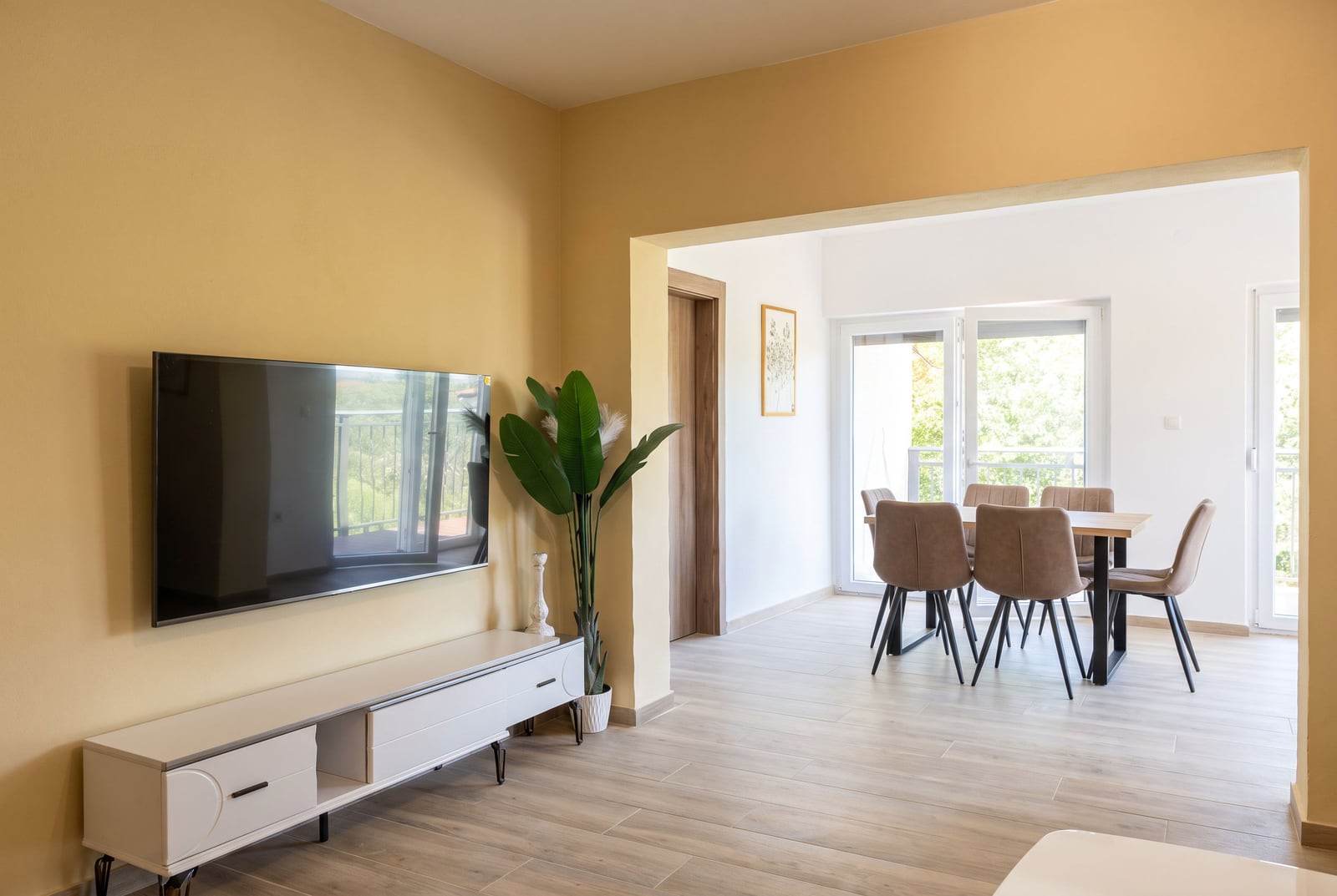 Living room with TV area and dining zone in an apartment in Bečići, Montenegro