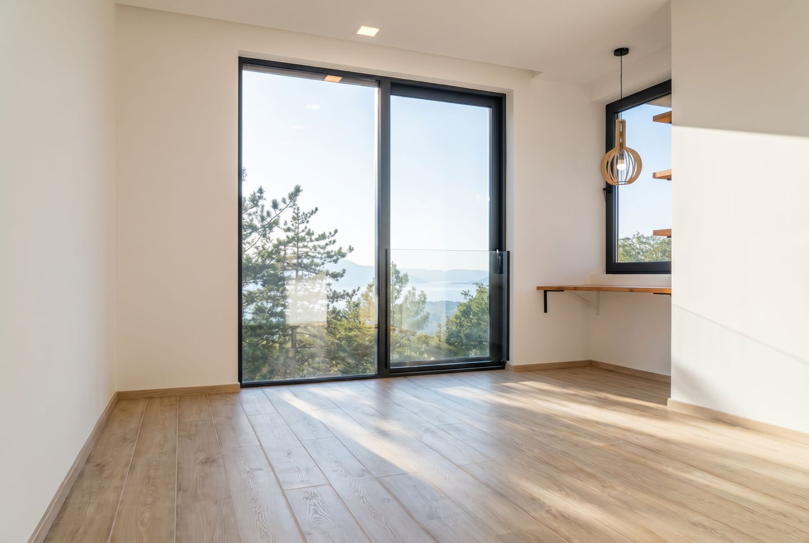 Living room with panoramic windows and sea view in a villa, Kavac, Montenegro: bright interior, wooden floor, and decor.