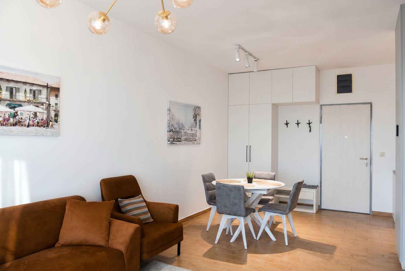 Modern living room with a brown sofa and dining area in an apartment, Becici, Montenegro.