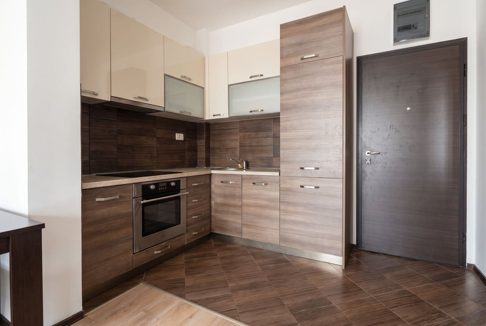 Modern kitchen with wood-style furniture and a stove in an apartment in Budva, Montenegro