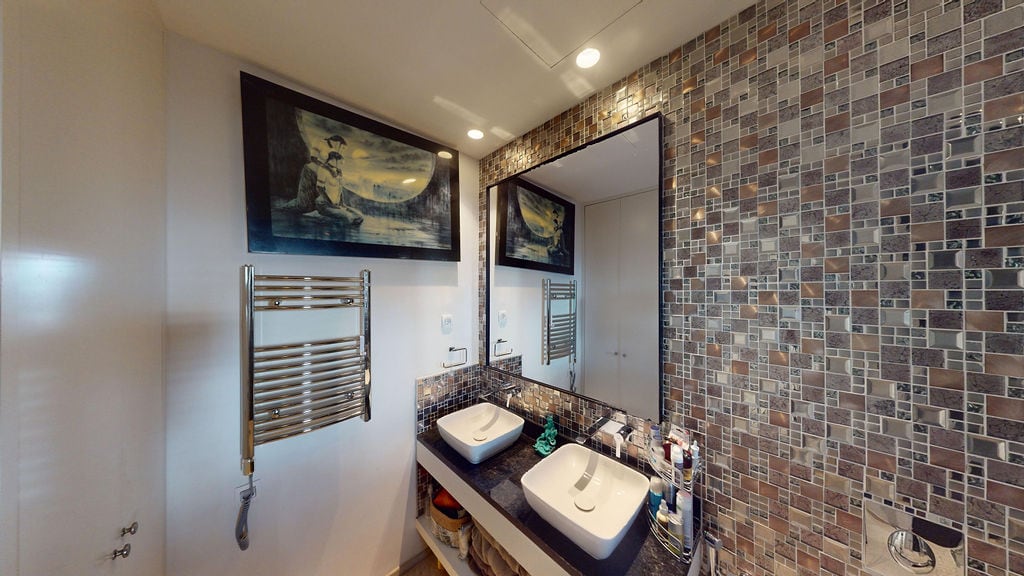 Modern bathroom with two sinks and mosaic tiles in a townhouse, Luštica, Montenegro.