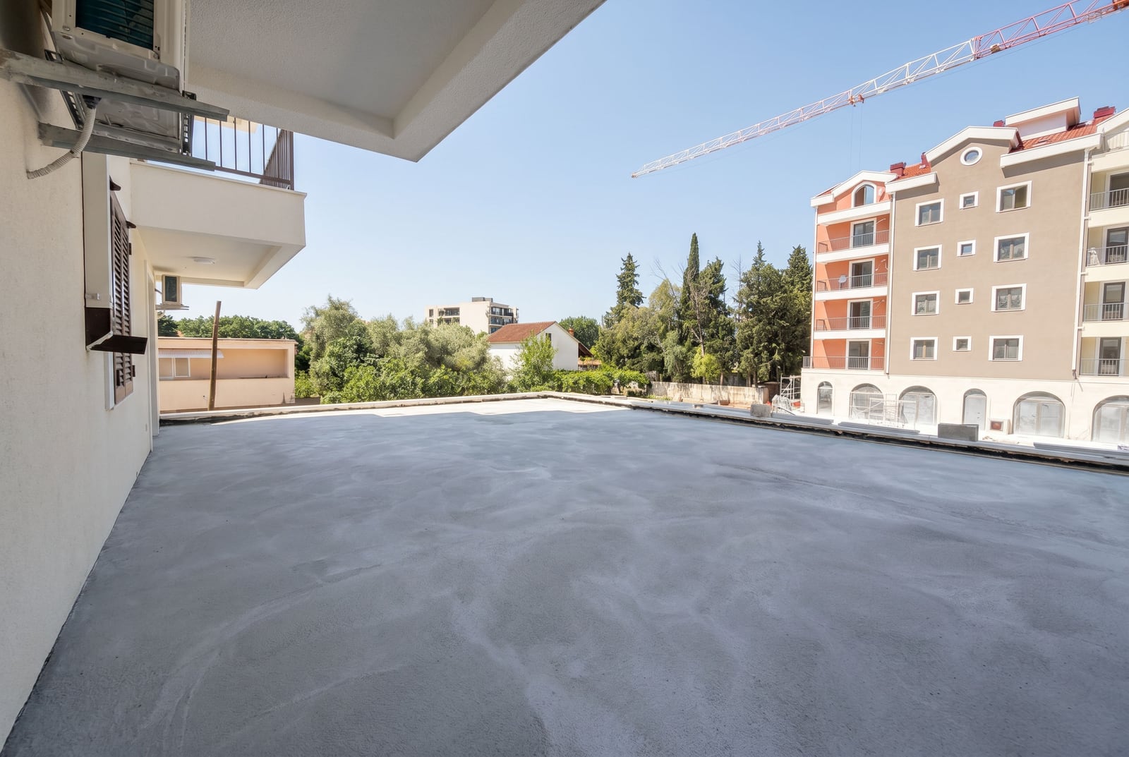 Spacious open concrete terrace in a residential complex under construction in Tivat, Montenegro.