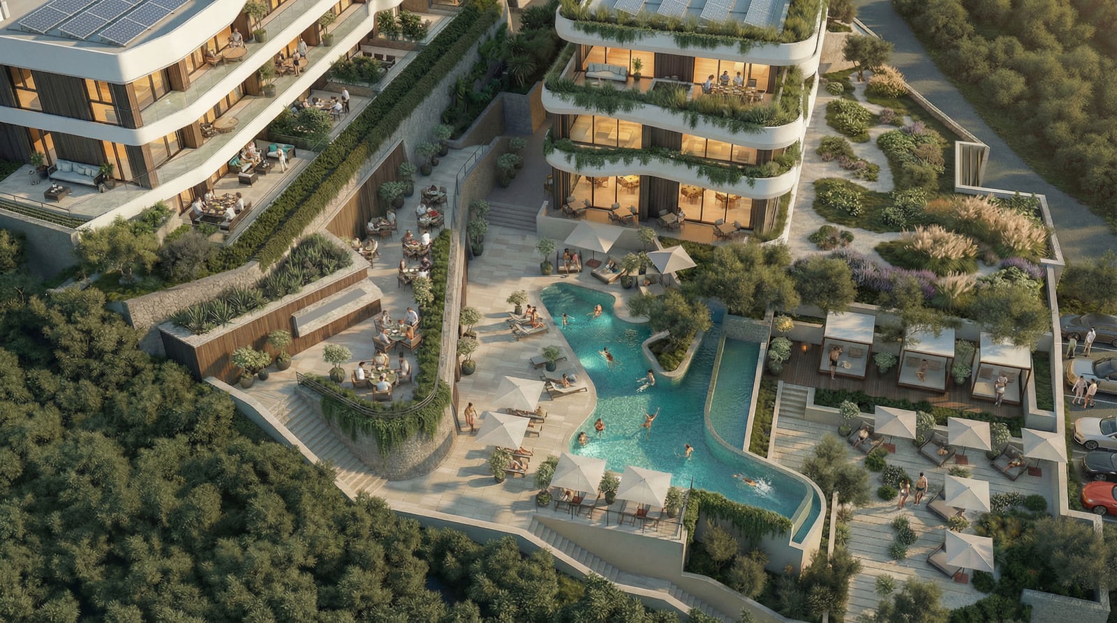 Aerial view of a resort complex featuring a winding pool, terraces, and lush green gardens.