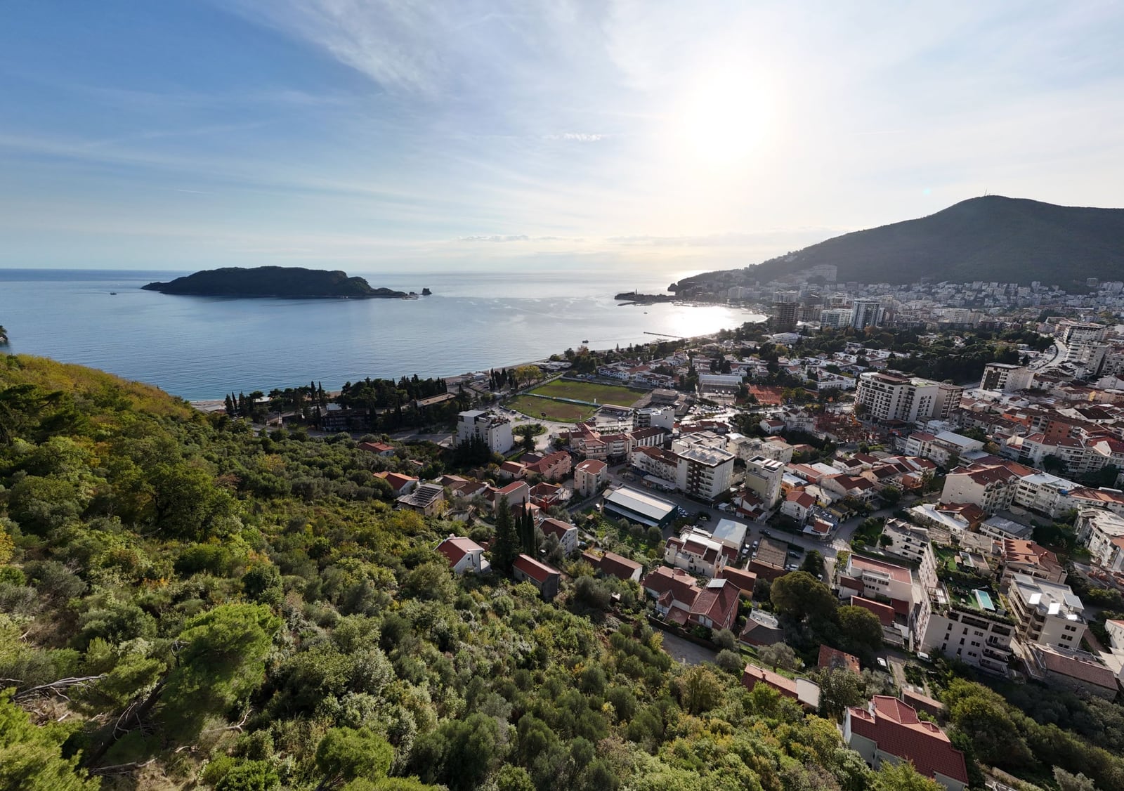 Panoramic view of Budva city and the island of Sveti Nikola in Montenegro from a hillside plot of land.