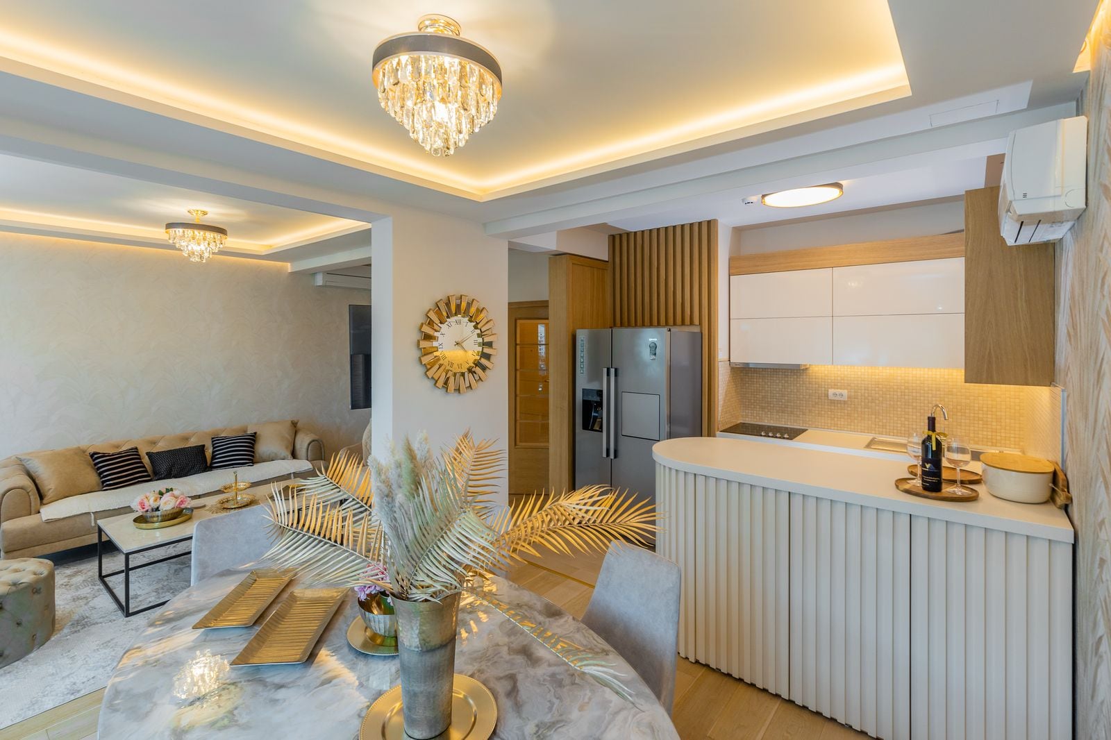 Modern living room with kitchen in a penthouse, Pržno, Montenegro: stylish interior, dining area, and soft seating.
