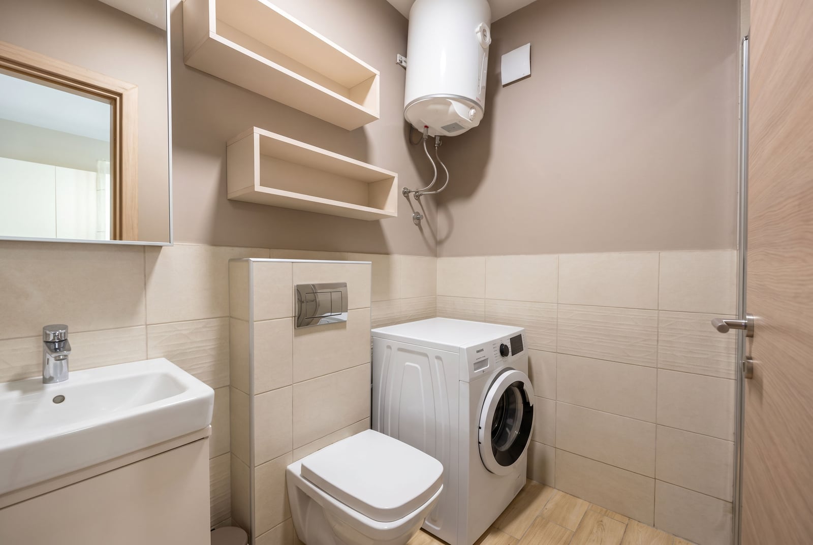 Bathroom featuring a toilet, sink, washing machine, wall-mounted water heater, and open shelves.