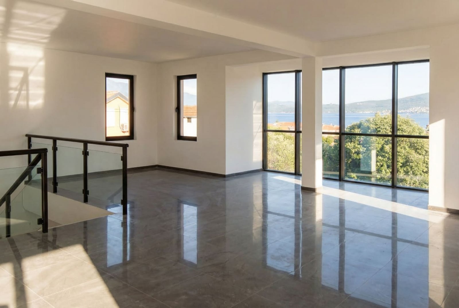Spacious living room with panoramic windows and sea view in Baošići, Herceg Novi, Montenegro, bright interior.