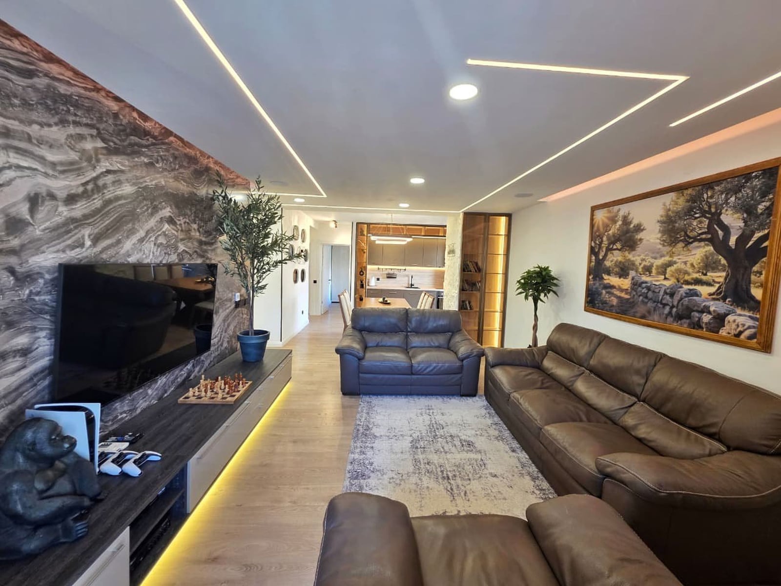 Modern living room with leather sofas and a marble wall in an apartment, Becici, Montenegro.