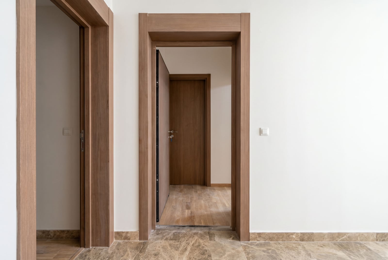 Wooden interior doors and marble flooring in a modern apartment in Tivat, Montenegro.