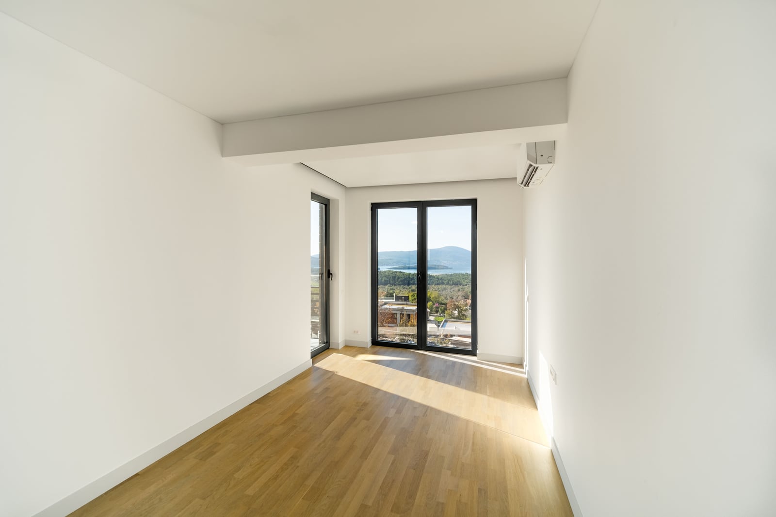 Bright living room with parquet flooring and panoramic sea views in a townhouse, Kavač, Montenegro.
