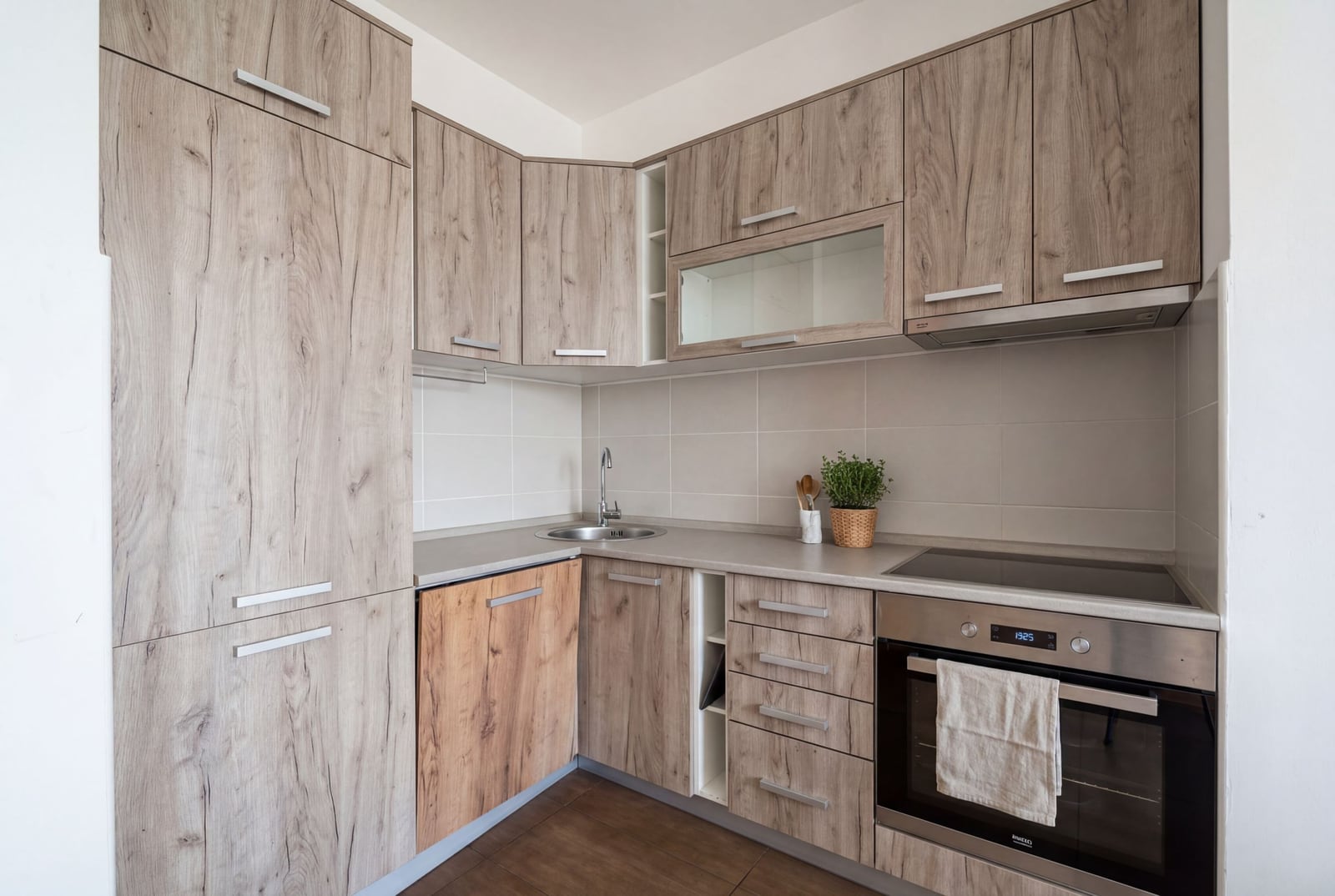 Modern kitchen with wooden fronts in an apartment in Bečići, Budva, Montenegro: built-in appliances and a bright design.