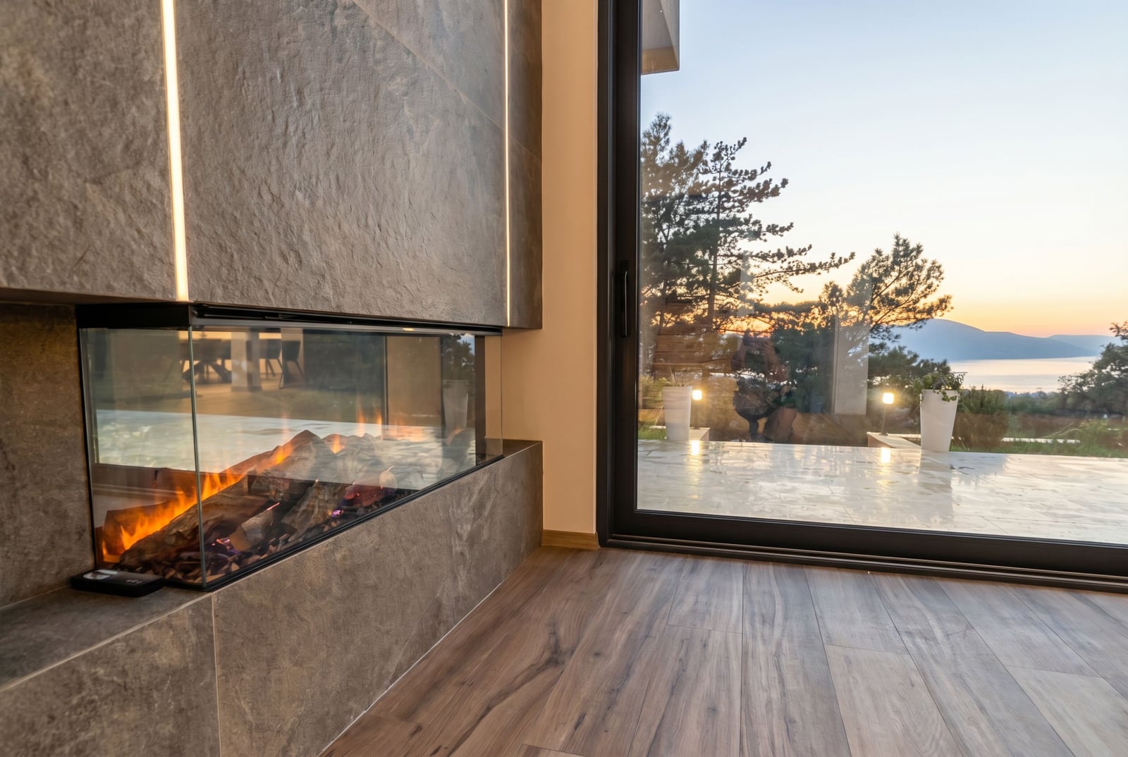 Modern living room with a fireplace and panoramic sea view in an exclusive villa, Kavac, Montenegro.