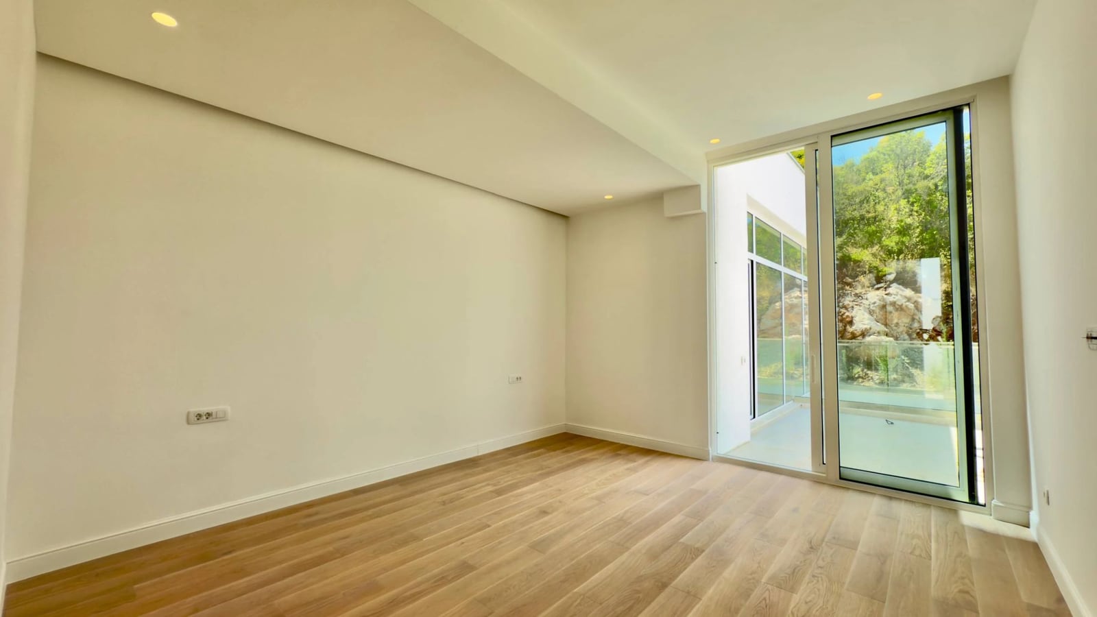 Bright living room with panoramic windows and a view of nature in a modern villa, Krašići, Montenegro.