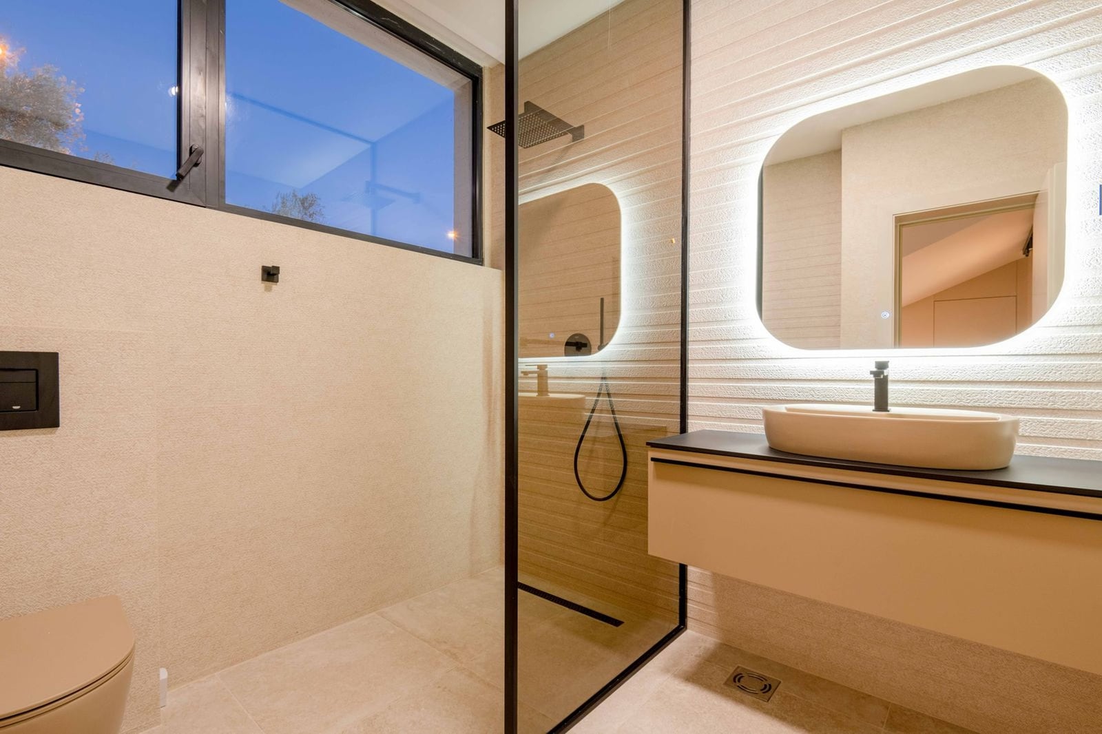 Modern bathroom in a villa in Kamenovo, Montenegro: shower cabin, illuminated mirror, and stylish finishes.