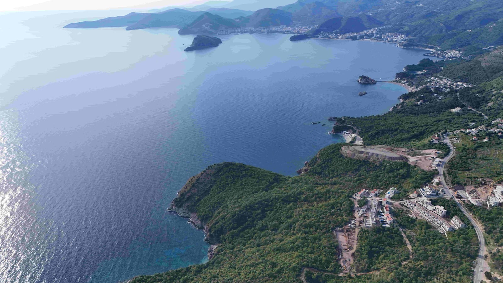 Aerial panoramic view of the Adriatic coast and a land plot in Reževići, Budva, Montenegro.