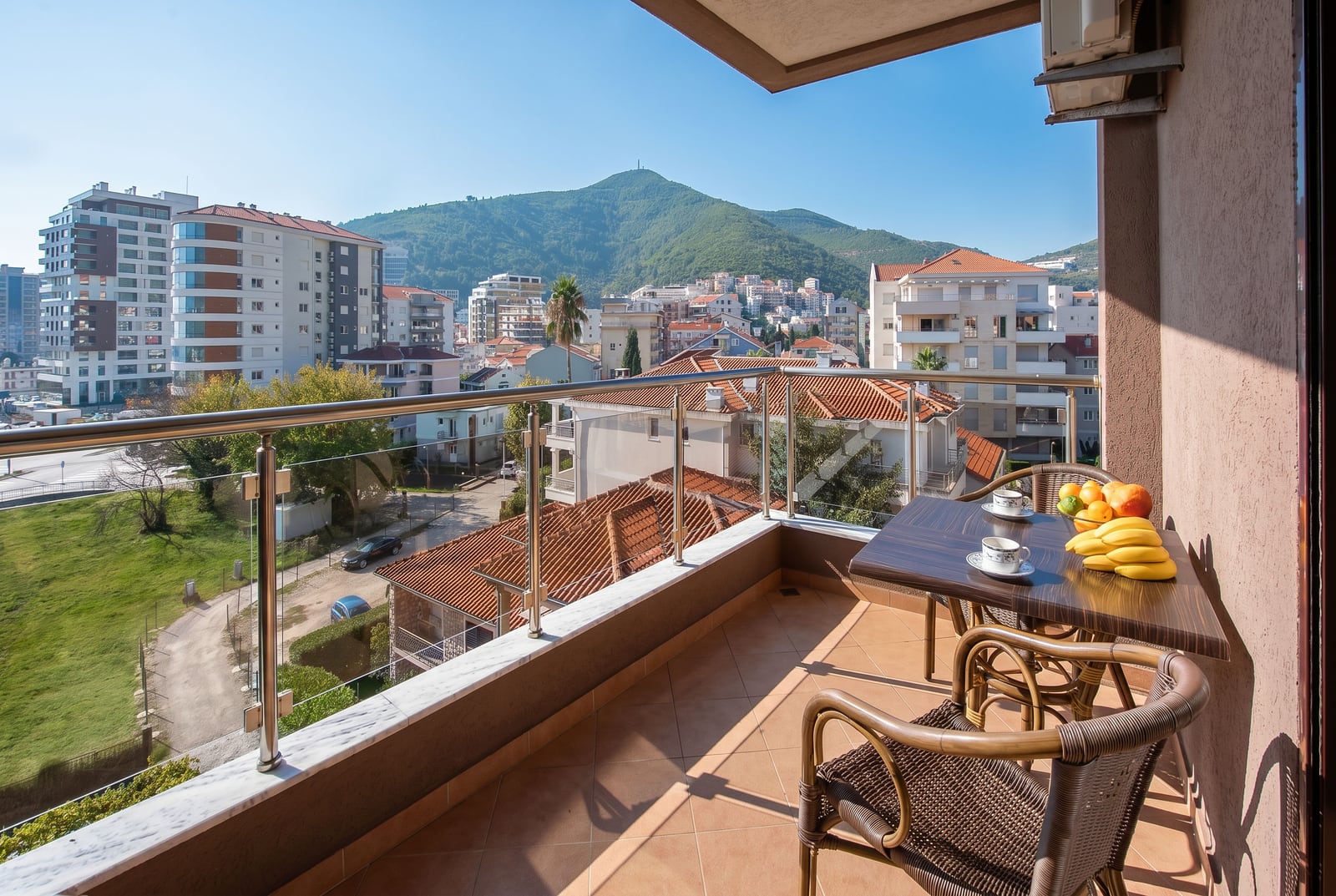 Balcony with furniture and panoramic views of the mountains and the city of Budva, Montenegro. Apartment No. 2713 with a terrace and views of the surroundings.