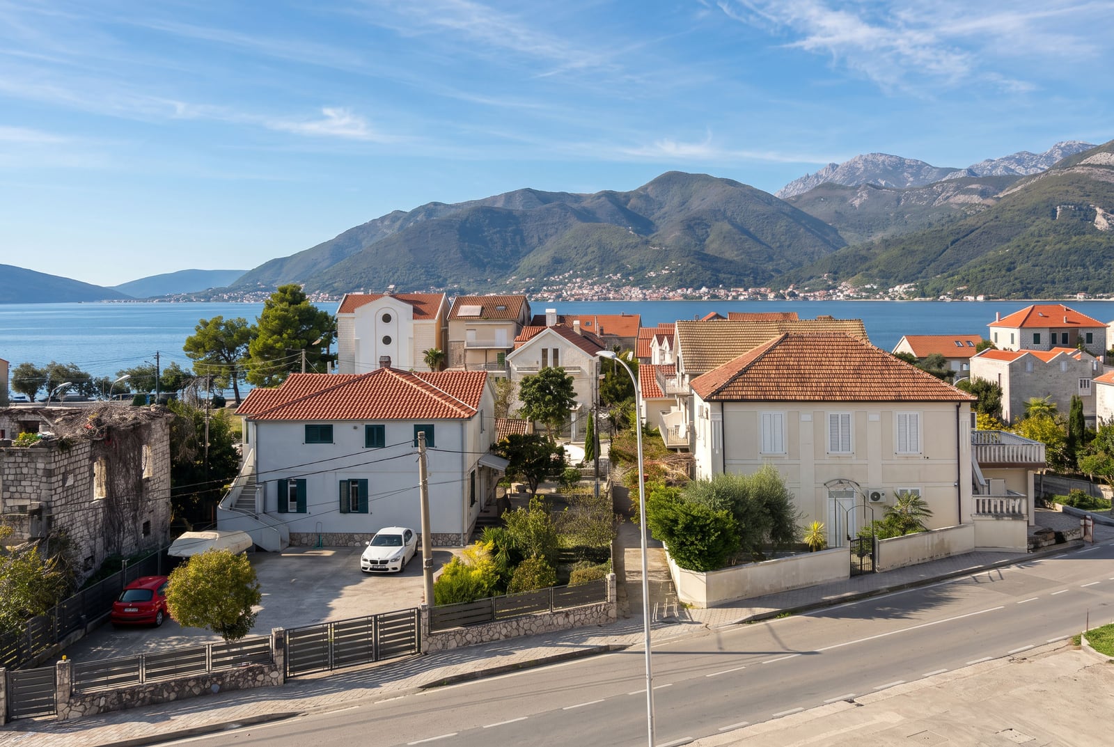 View of Mediterranean houses, the bay, and mountains in Tivat, Montenegro