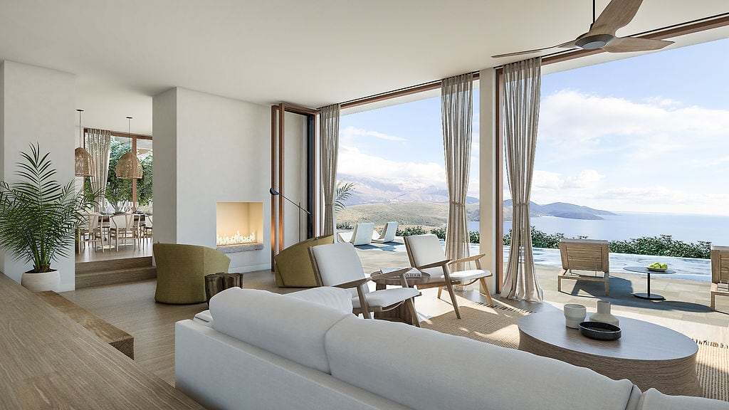 Modern living room in a villa in Luštica, Montenegro: panoramic sea view, fireplace, terrace with pool, and stylish furniture.