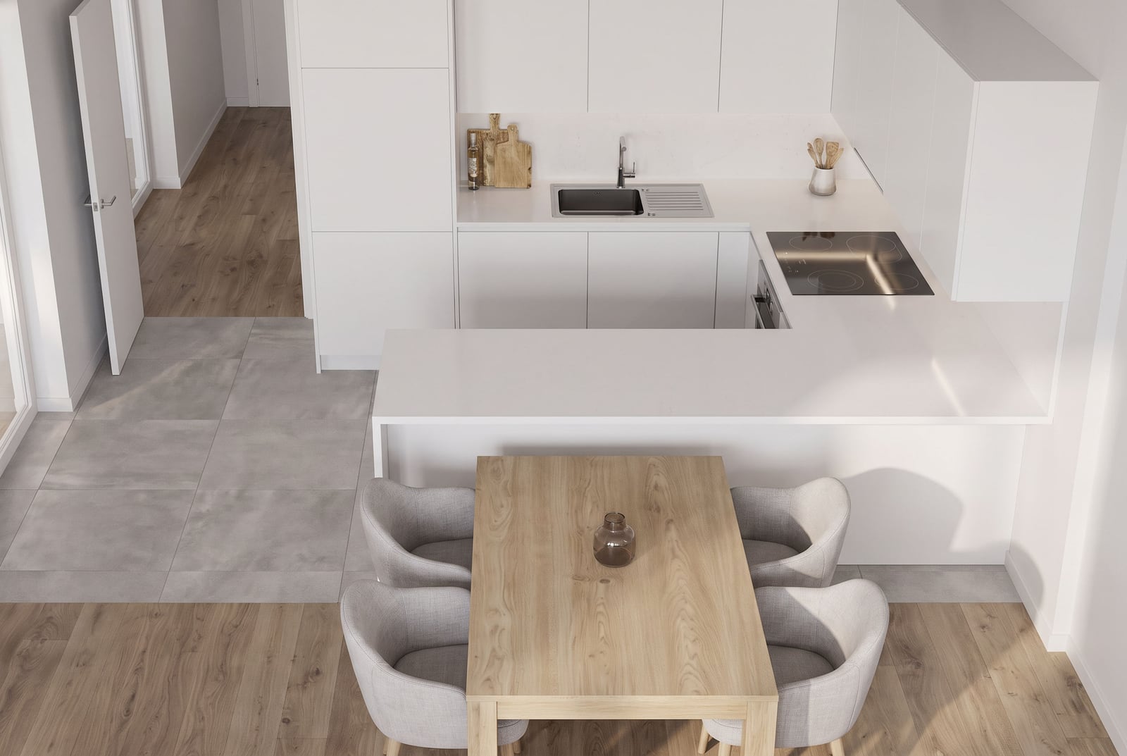 Modern white kitchen with a dining area in a residential complex in Bečići, Montenegro: top-down view of the interior with a wooden table.