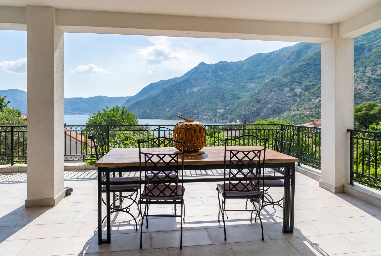 Terrace with a dining area and panoramic view of the Bay of Kotor and mountains, Risan, Montenegro.