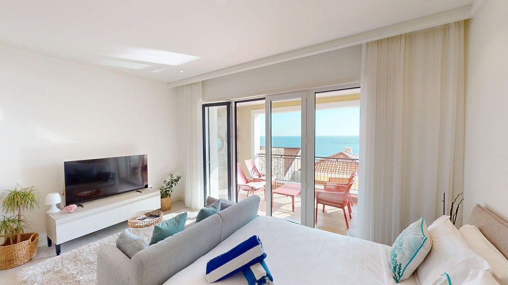 Bright bedroom with sea view and terrace in Luštica apartments, Montenegro: modern furniture and panoramic windows.