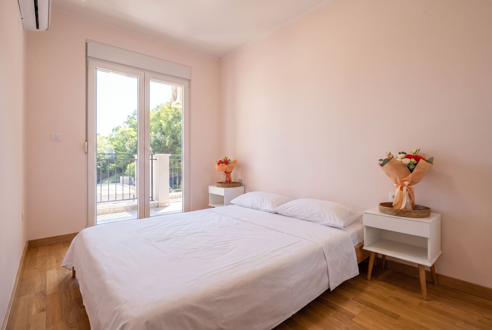 Bright bedroom with a double bed and balcony access in an apartment, Budva, Montenegro.