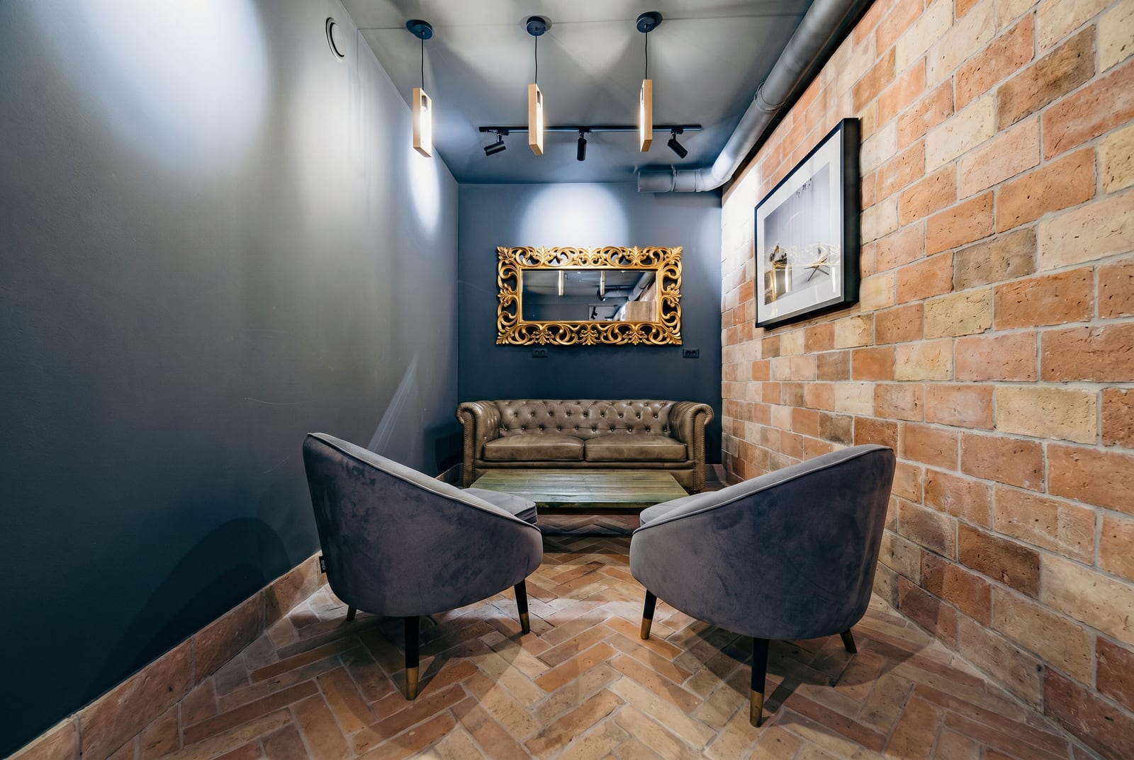 Loft-style living room with a brick wall and leather sofa in a residential complex, Kumbor, Montenegro.