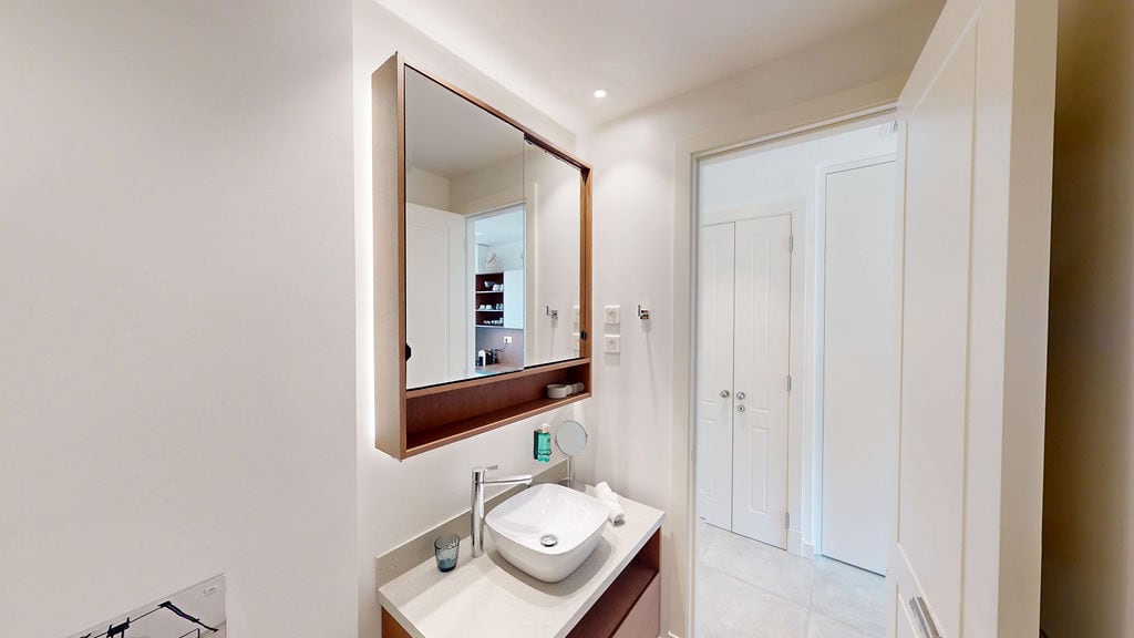 Modern bathroom with a mirror and vanity unit in an apartment in Luštica, Montenegro: stylish interior and finishes.