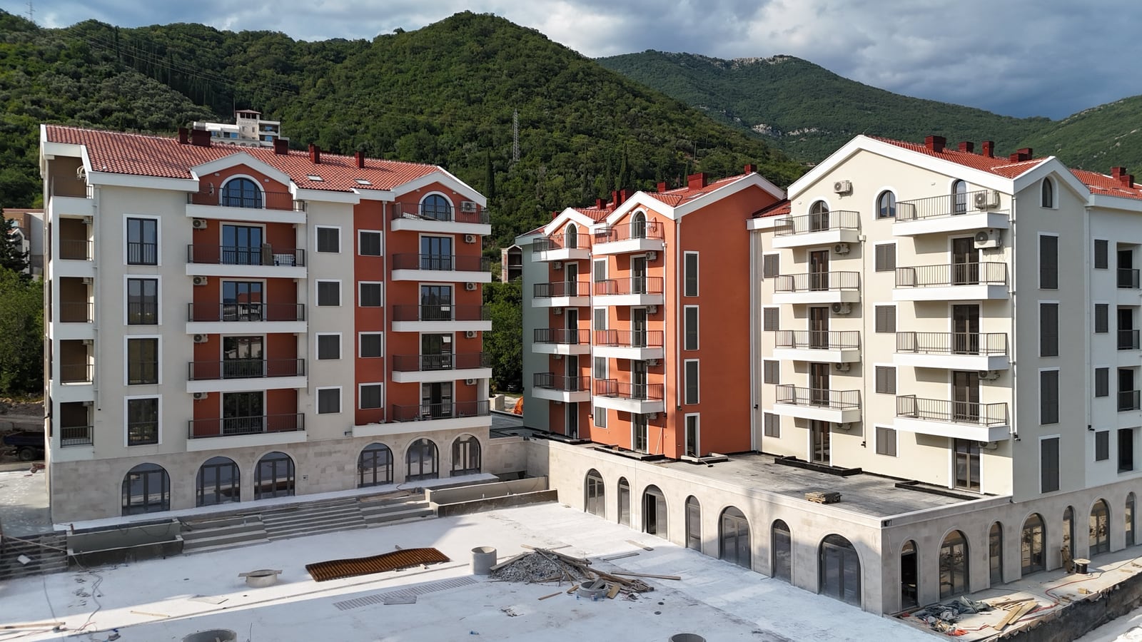 Modern residential complex with terraces and mountain views in Tivat, Montenegro: exterior of new apartment buildings.