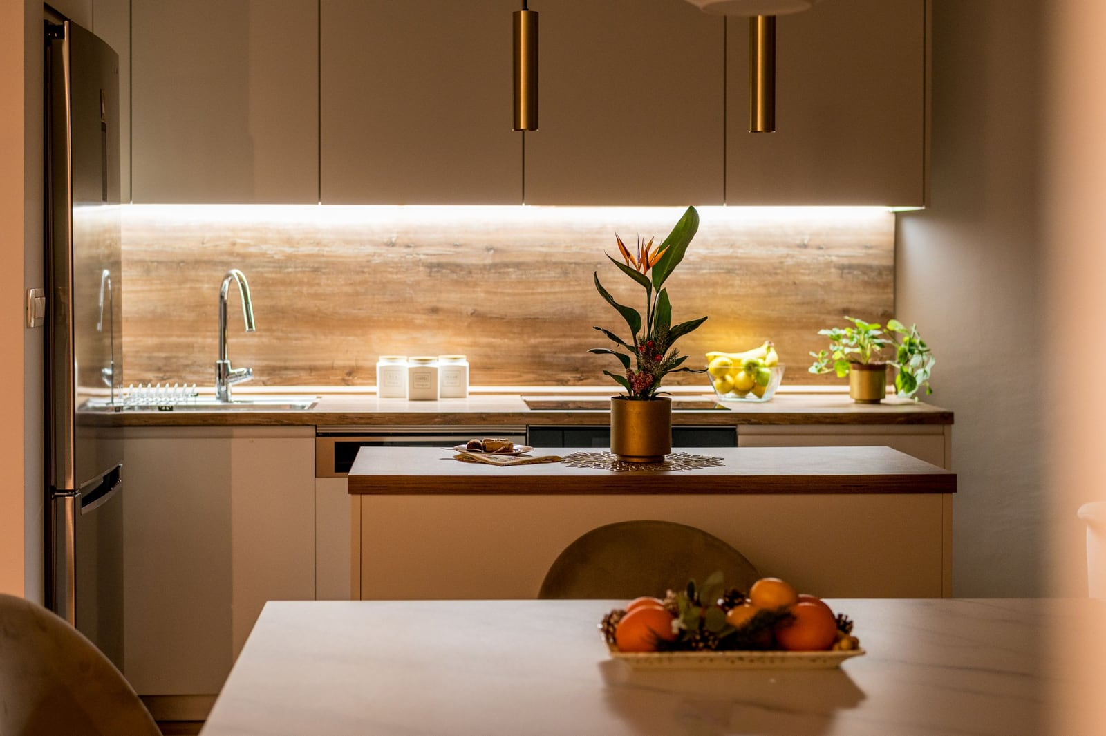Modern kitchen in a Tivat apartment, Montenegro: light-colored cabinetry, wooden countertop, and stylish lighting.