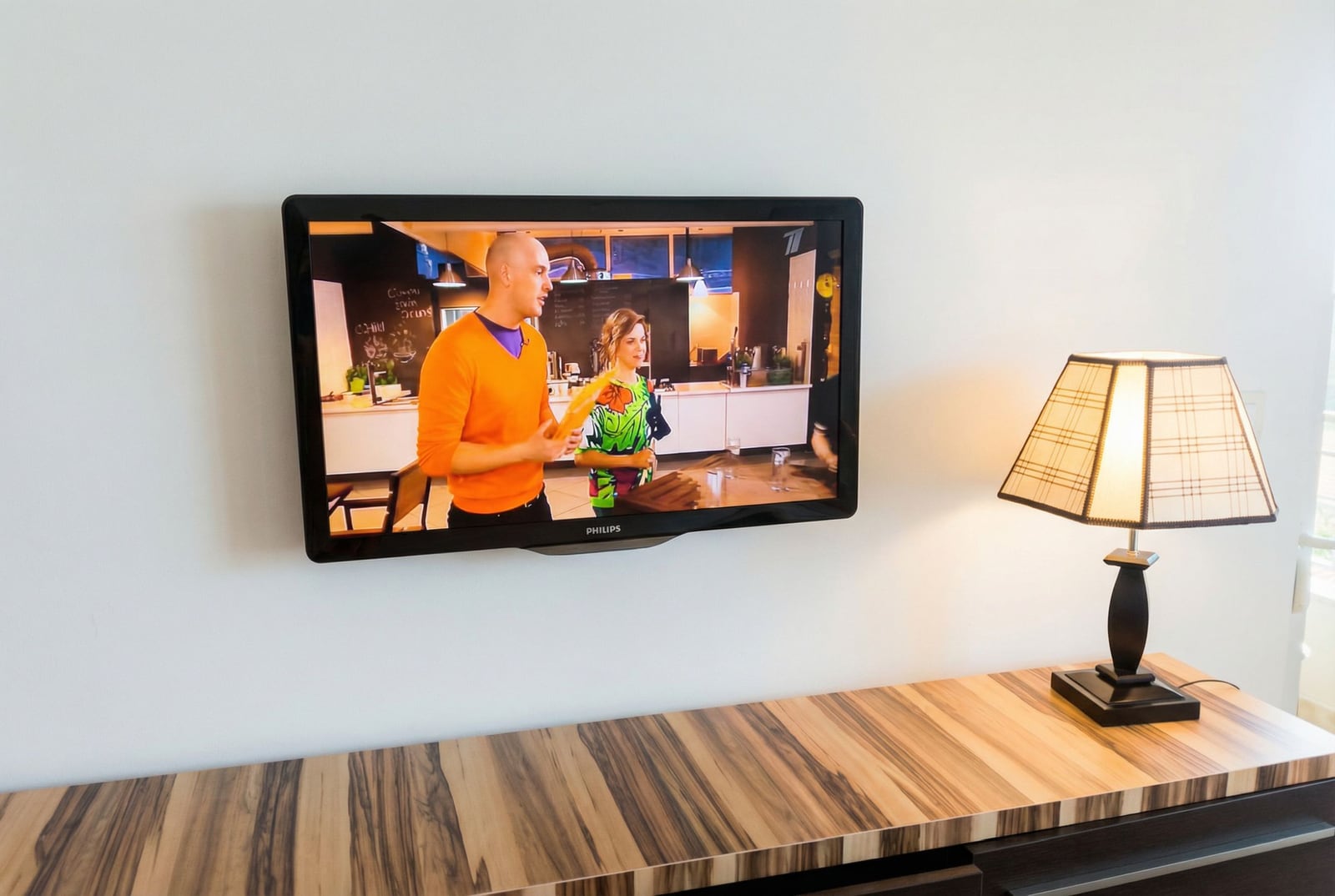 Philips TV on the wall and a table lamp in the living room of an apartment in Petrovac, Montenegro.