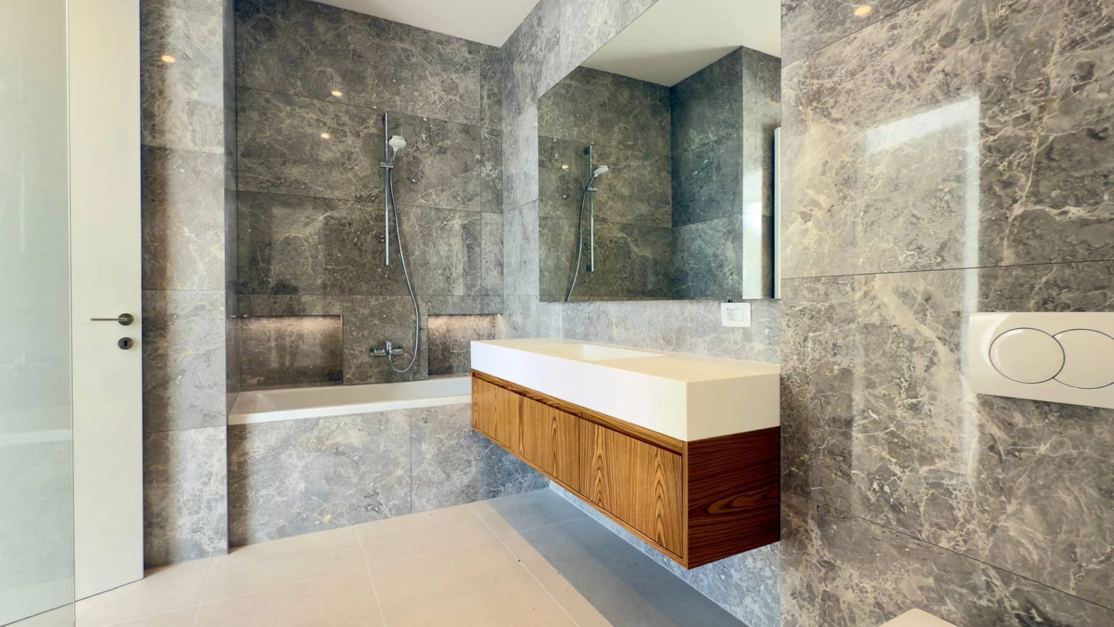 Modern bathroom with gray marble finishes and a wooden vanity in a villa in Krašići, Montenegro.