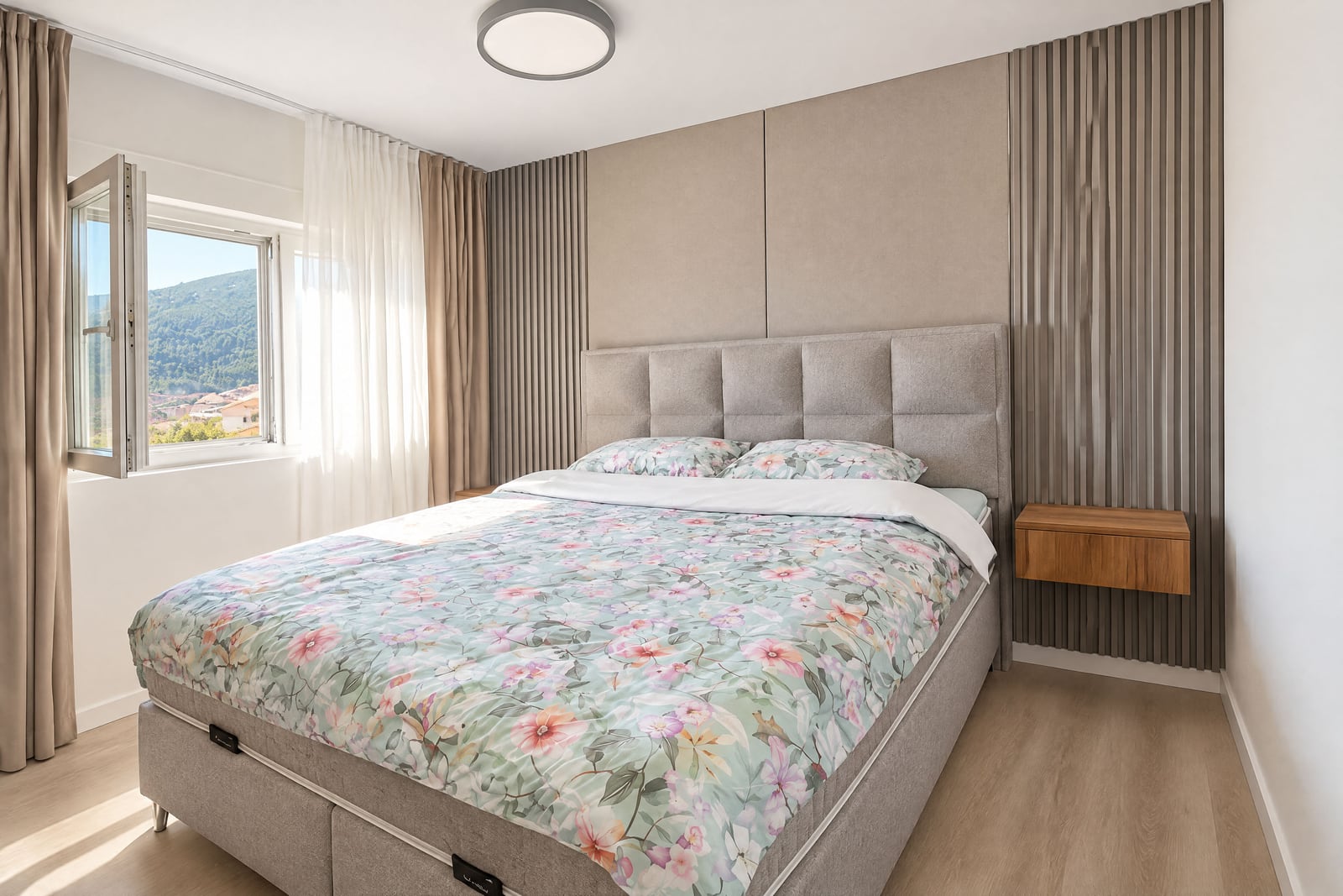 Modern bedroom featuring a double bed with floral bedding, upholstered headboard, and wooden slat wall paneling.