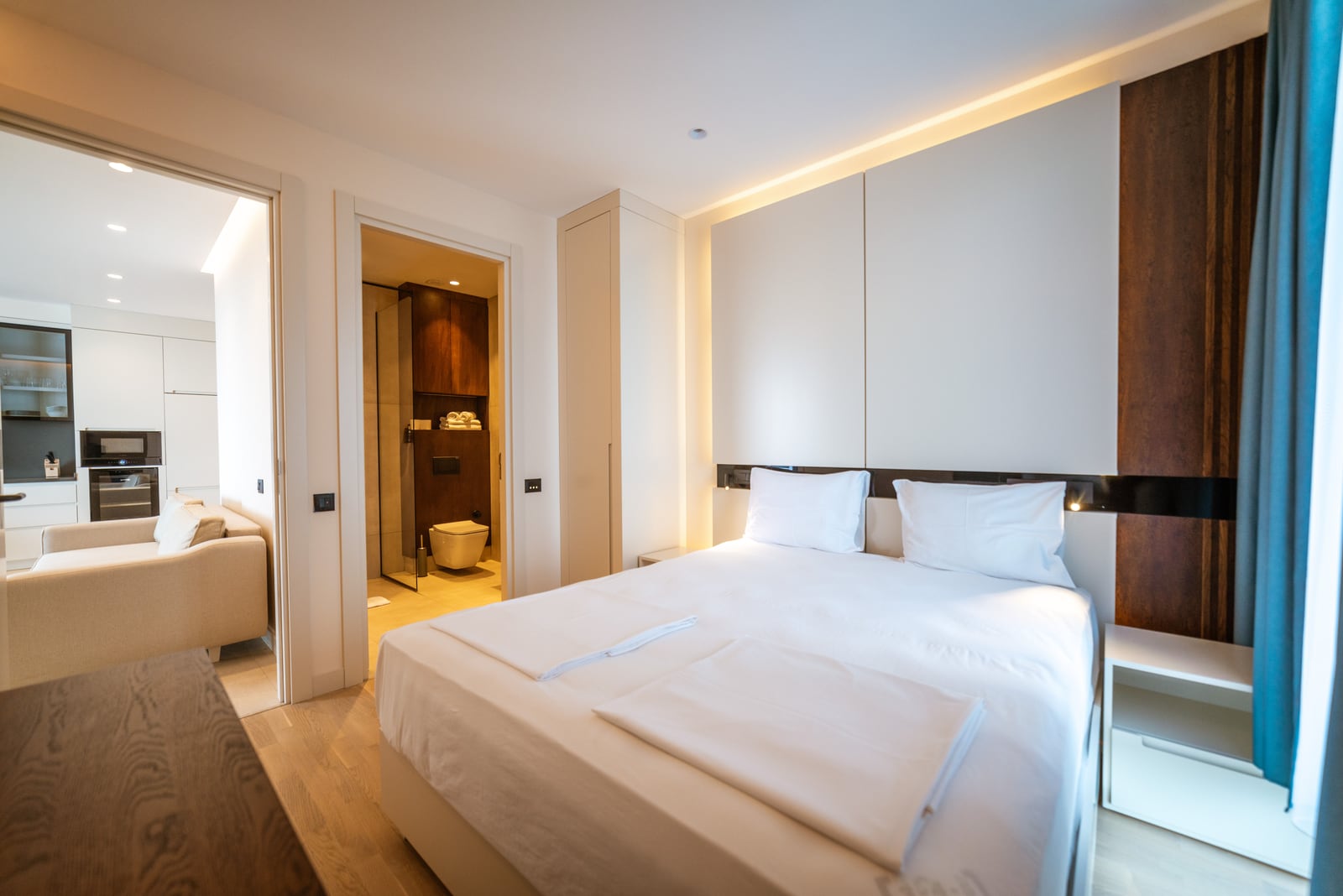 Modern bedroom with a double bed and bathroom in an apartment in Bečići, Montenegro.