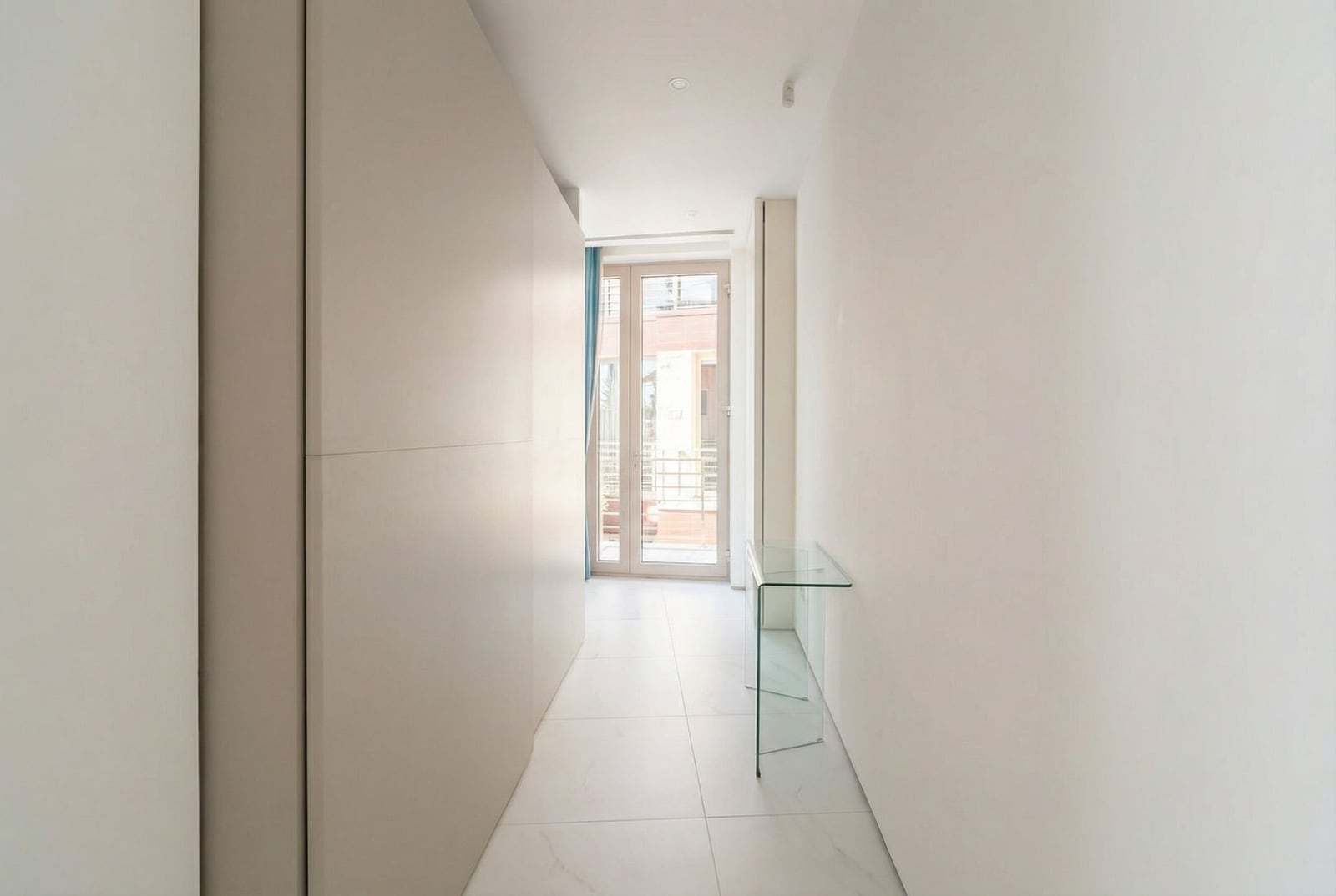 Bright hallway with a built-in wardrobe and a glass console in an apartment in Dukley, Budva, Montenegro.