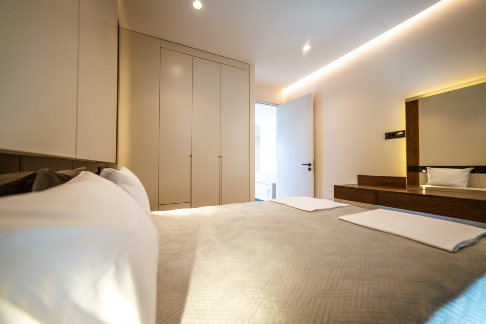 Modern bedroom with a double bed and built-in wardrobe in an apartment, Bečići, Montenegro.