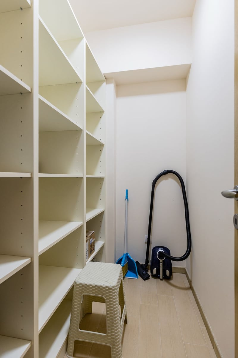 Spacious walk-in closet with shelving in an apartment in Pržno, Montenegro: light finishes and storage space.