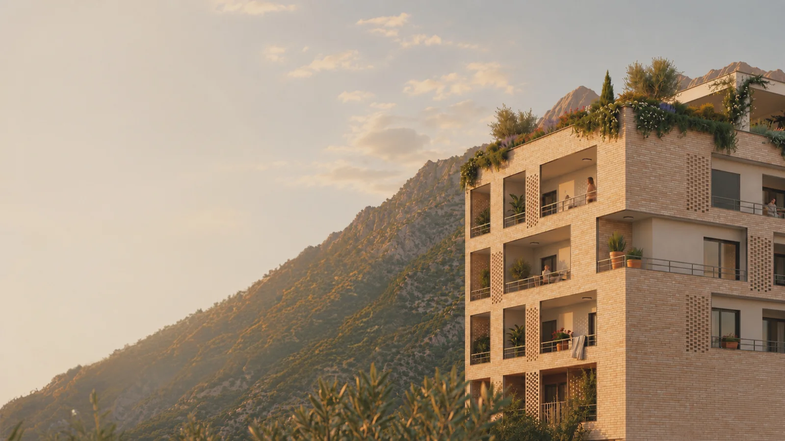 Exterior of a multi-story brick building with balconies set against a mountain slope.