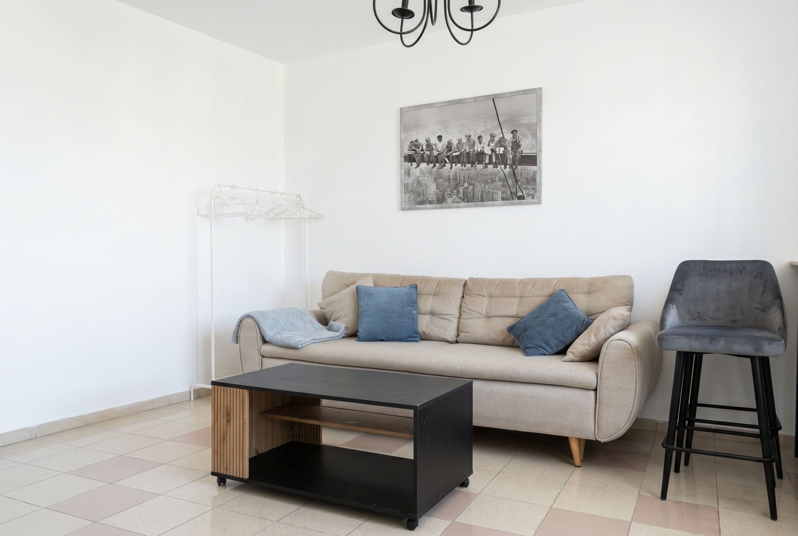 Bright living room in an apartment in Budva, Montenegro: beige sofa, coffee table, and modern interior finishes.