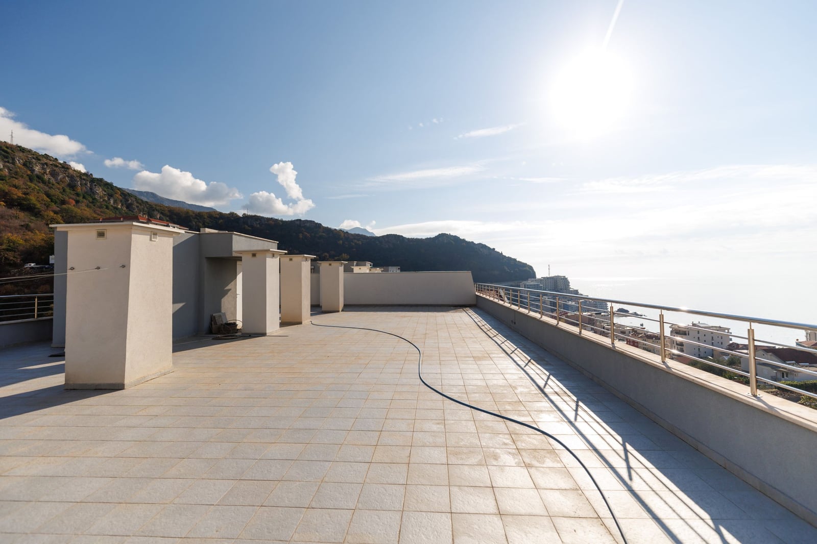 Spacious open penthouse terrace in Bečići, Montenegro, with panoramic sea and mountain views.