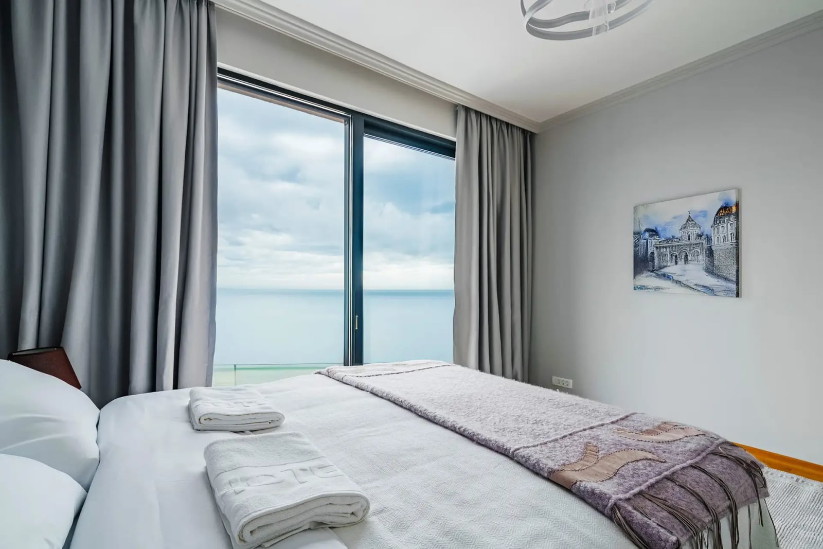 Bedroom with a panoramic sea view in a villa, Reževići, Montenegro: double bed, modern interior.