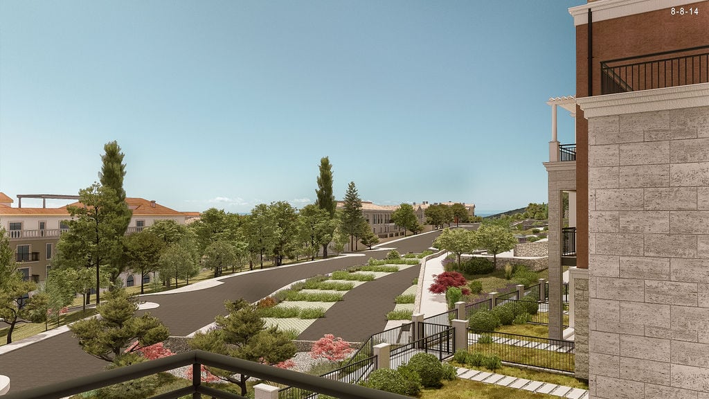 View from the balcony onto the landscaped grounds of a residential complex in Luštica, Montenegro: roads, greenery, and architecture.