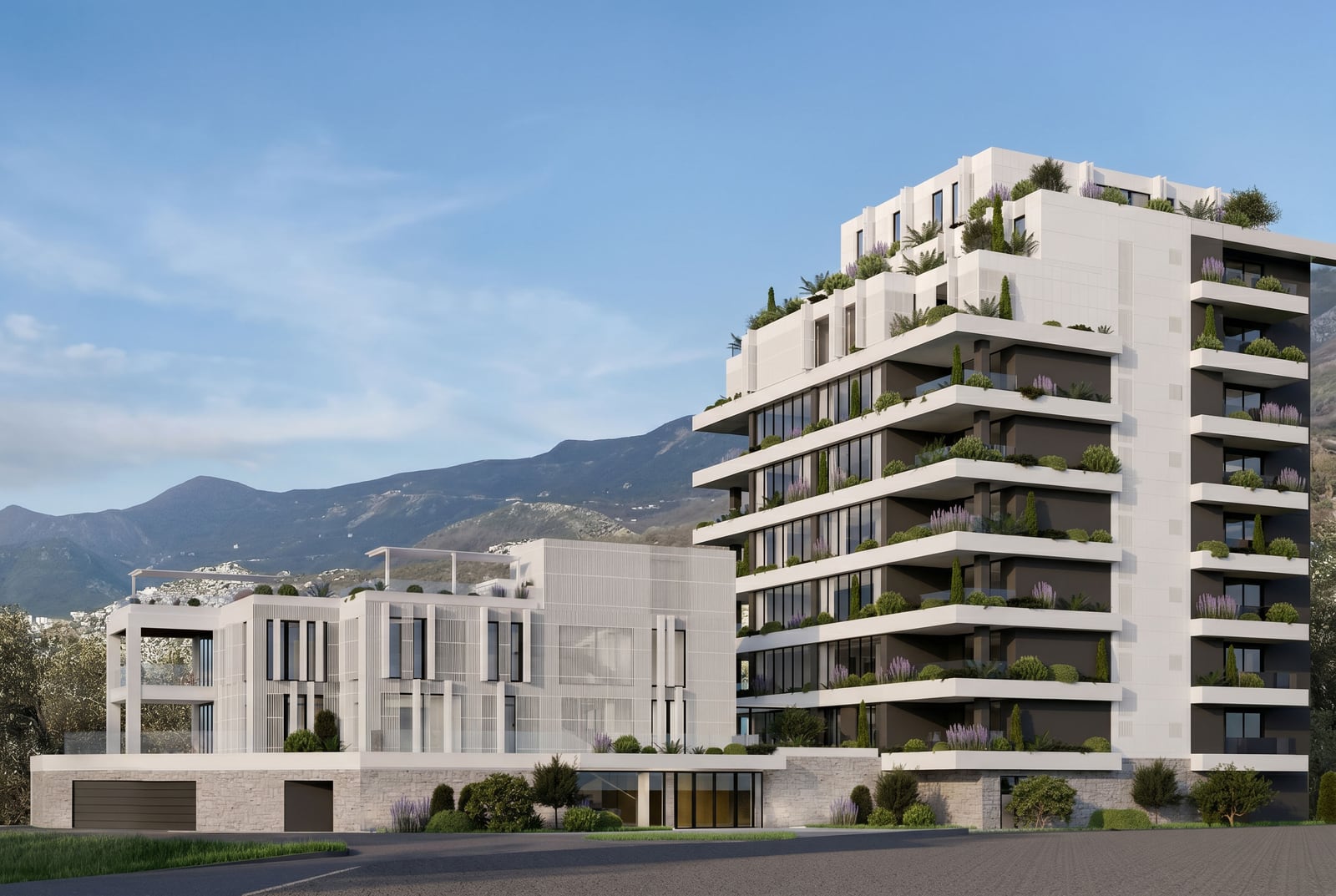 Modern residential complex with terraces and landscaping in Sveti Stefan, Montenegro: view of the building and mountains.