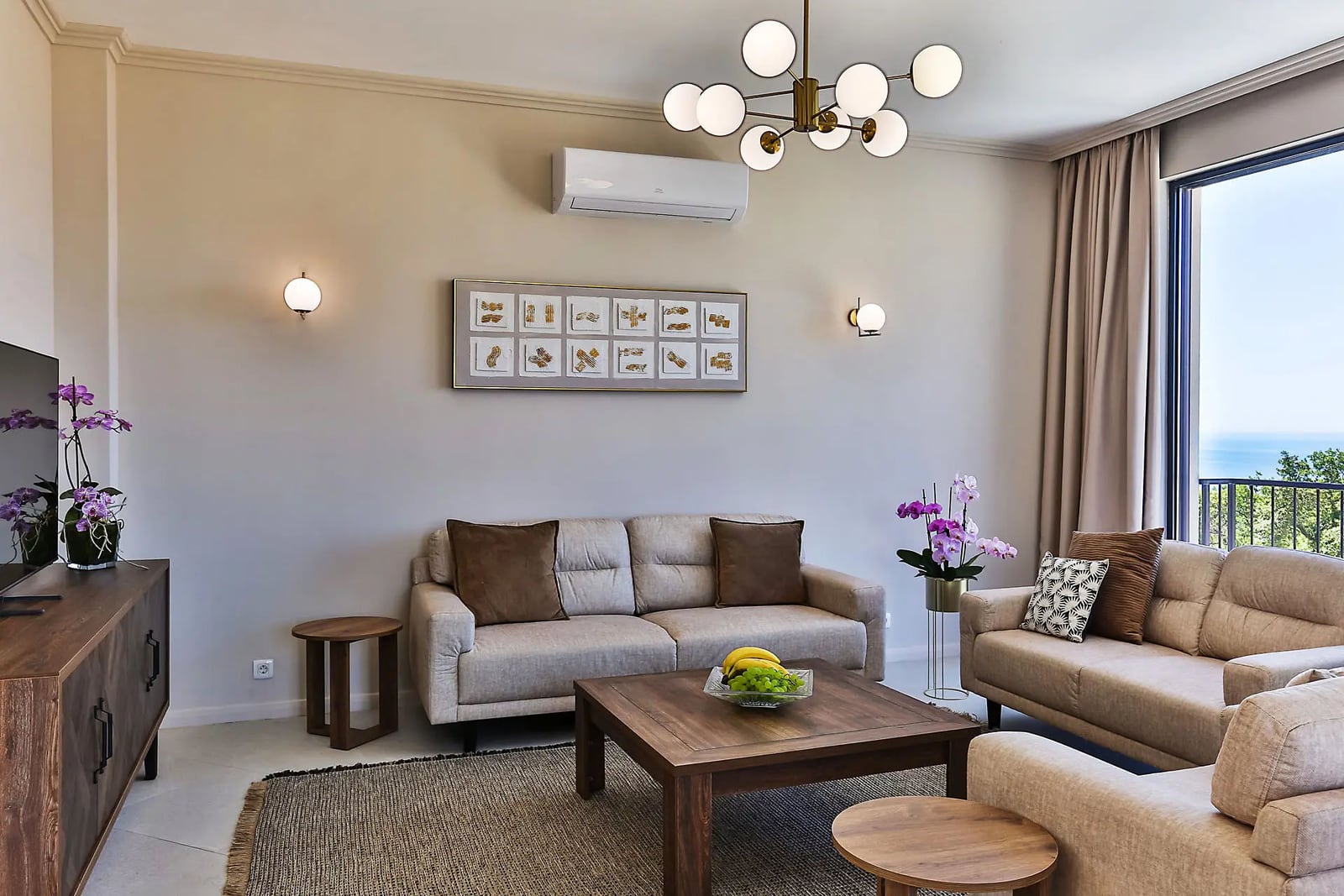 Bright living room with modern furniture and a sea view in a villa in Reževići, Montenegro: cozy interior with decor.