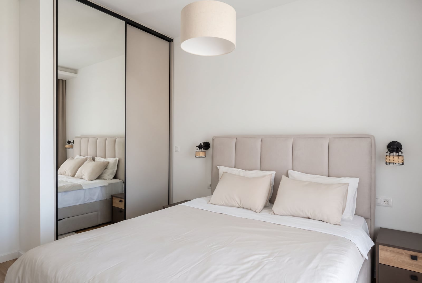 Modern bedroom with a double bed and mirrored wardrobe in an apartment, Dobrota, Montenegro.