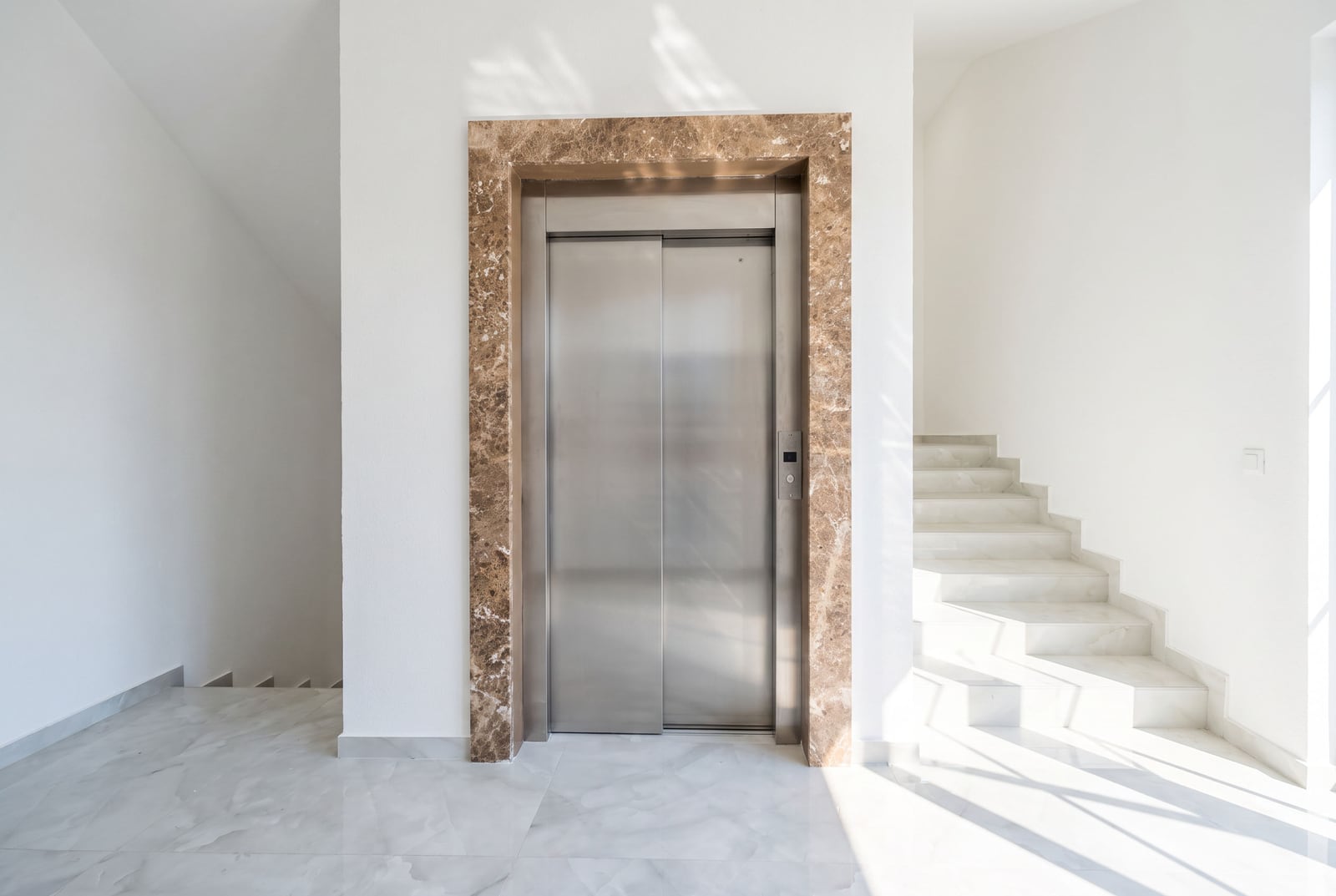 Modern elevator with marble portal trim and staircase in an upscale building in Bar, Montenegro.