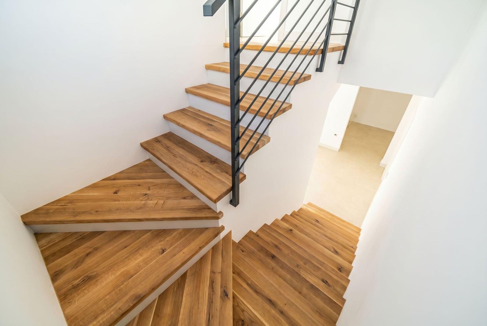 Modern wooden staircase with metal railings in a townhouse, Kavac, Montenegro. Home interior.