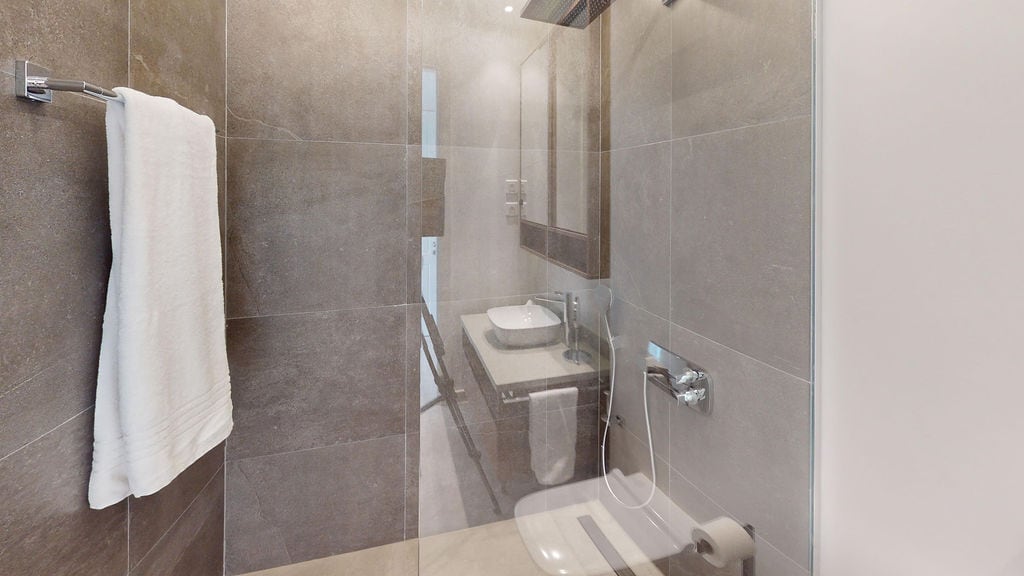 Modern bathroom with a shower cabin and porcelain stoneware finish in an apartment, Luštica, Montenegro.