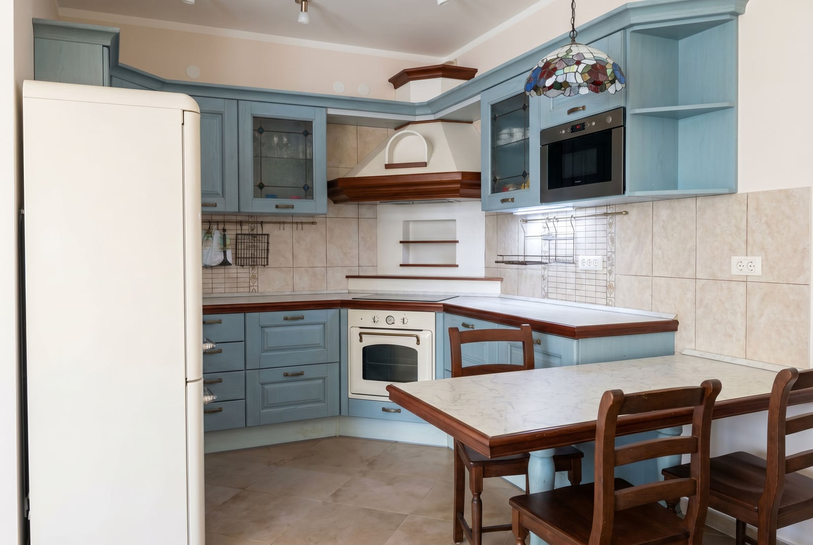 Cozy classic-style kitchen with blue cabinetry in an apartment, Bar, Montenegro.