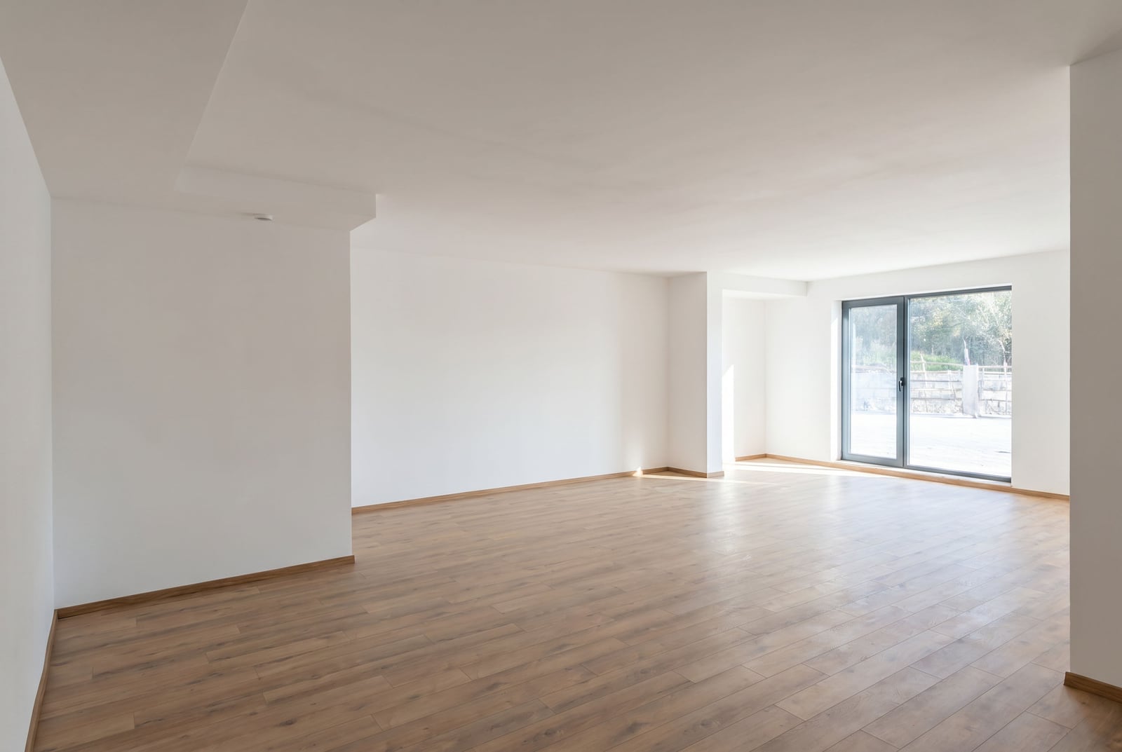Spacious bright living room with turnkey finishing and laminate flooring in a new apartment in Pržno, Montenegro.